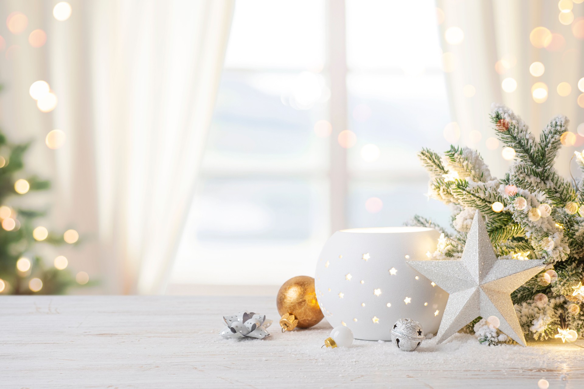 Cozy Christmas table top with decorations and snow on blur abstract holiday background